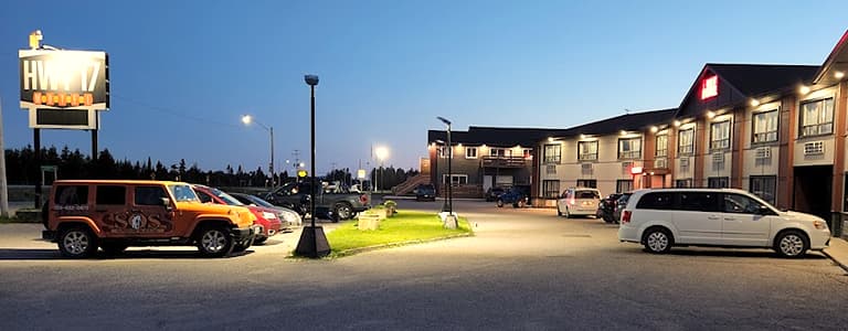 HWY 17 Hotel parking lot well lit at night time with cars securely visible